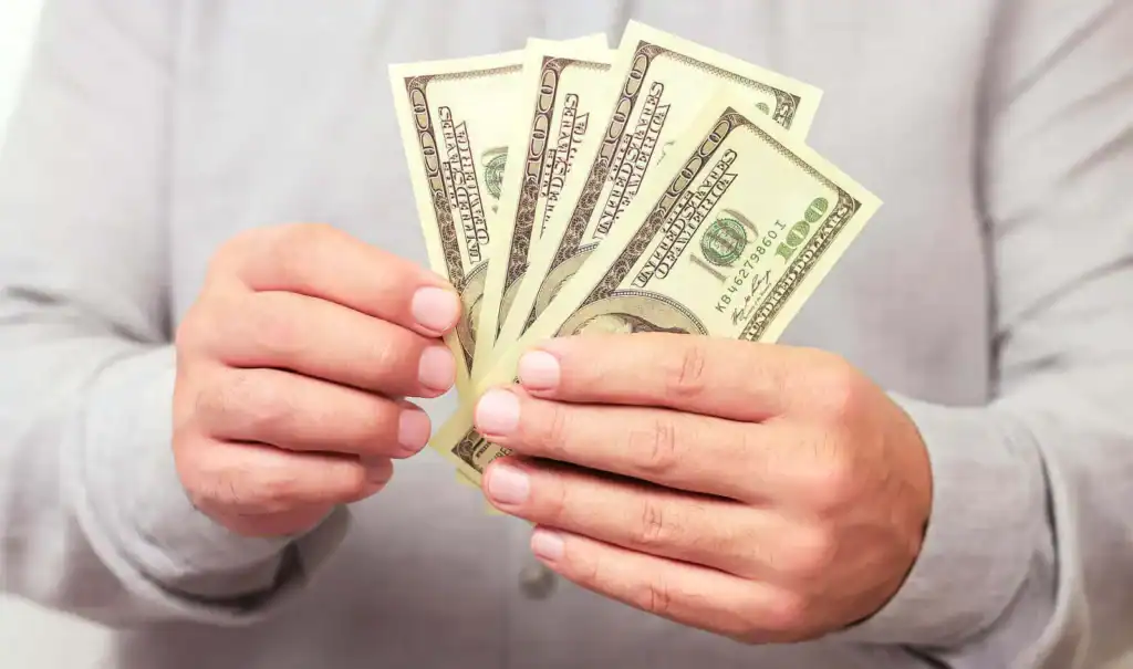 Finance, investment or money saving concept. Man holding paper us dollars